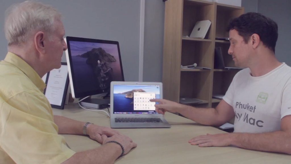 An independent Mac technician helping fix a broken MacBook in Phuket